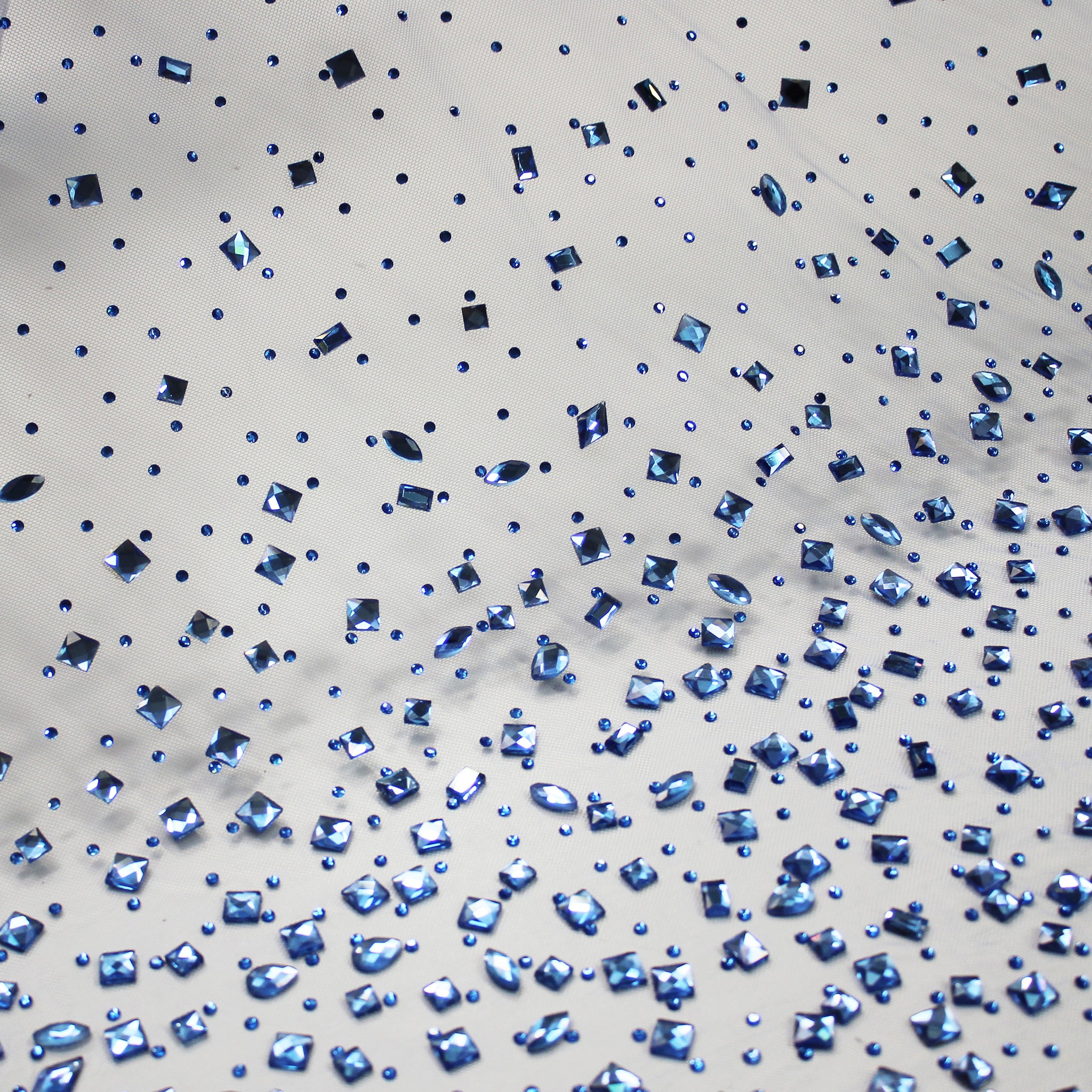 Tulle embroidered with rhinestones and multi-shaped stones in a tone-on-tone degradé effect
